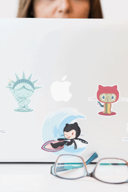 woman using a laptop with git stickers